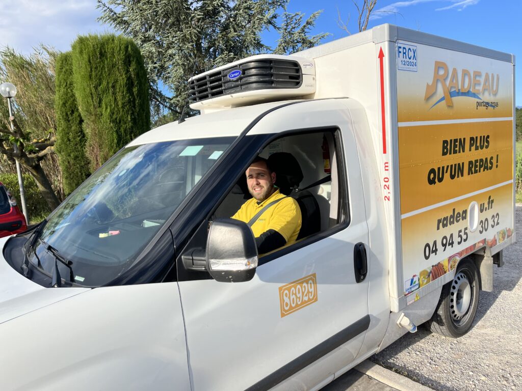 livreur conduisant un camion frigorifique radeau